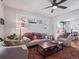 Bright living room with stylish furnishings, a ceiling fan, and large windows offering ample natural light at 6940 W 48Th Ave, Wheat Ridge, CO 80033
