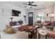 Inviting living room features modern furnishings, a ceiling fan, and a sleek entertainment center at 6940 W 48Th Ave, Wheat Ridge, CO 80033