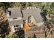 Aerial view of a two-story home with large windows, a wooden deck, and a fenced-in yard at 29089 Western Ln, Evergreen, CO 80439