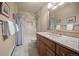 Well-lit bathroom featuring granite counters, a shower-tub combo, and neutral tile at 29089 Western Ln, Evergreen, CO 80439