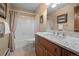 Bathroom with vanity, framed mirror, and shower-tub combination at 29089 Western Ln, Evergreen, CO 80439