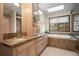 Bathroom with double sinks, marble countertops, and a luxurious soaking tub at 29089 Western Ln, Evergreen, CO 80439