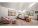 Bright bedroom with two windows, a comfortable armchair, and a decorative area rug at 29089 Western Ln, Evergreen, CO 80439