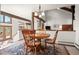 Cozy dining area with wooden table and chairs, showcasing the open floor plan at 29089 Western Ln, Evergreen, CO 80439