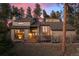 Lovely exterior shot of house with neutral siding, large windows, and a fenced yard at 29089 Western Ln, Evergreen, CO 80439