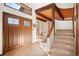 Inviting foyer with wood-beamed ceilings and staircase leading to the upper level at 29089 Western Ln, Evergreen, CO 80439