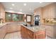 Kitchen features granite countertops, an island cooktop, and sleek, stainless steel appliances at 29089 Western Ln, Evergreen, CO 80439