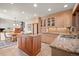 Granite countertops and wooden island in the kitchen are situated next to a breakfast nook at 29089 Western Ln, Evergreen, CO 80439