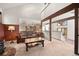 Comfortable living room with wood beams, offering a view to the kitchen and dining area at 29089 Western Ln, Evergreen, CO 80439