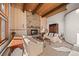 Inviting living room boasting a stone fireplace, wood accents, and comfortable seating at 29089 Western Ln, Evergreen, CO 80439