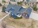 Stunning aerial view of blue two-story home with beautifully landscaped yard and a backyard green at 5372 Lenox Ct, Castle Rock, CO 80104