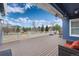 Covered outdoor deck with wood floors, a white railing, and furniture for relaxation overlooking backyard at 5372 Lenox Ct, Castle Rock, CO 80104