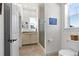 Bright bathroom featuring a sink, toilet, shower, and window offering plenty of natural light at 5372 Lenox Ct, Castle Rock, CO 80104