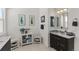 Stylish bathroom with dark vanity, tile backsplash, and decorative art and accessories at 5372 Lenox Ct, Castle Rock, CO 80104
