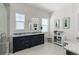 Bright bathroom featuring double windows, a vanity with plenty of cabinet space, and elegant decor at 5372 Lenox Ct, Castle Rock, CO 80104