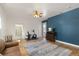 Bonus room featuring hardwood floors, a ceiling fan, exercise equipment, and a blue accent wall at 5372 Lenox Ct, Castle Rock, CO 80104