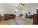Bonus room with a ceiling fan, hardwood floors, a leather sofa, and exercise equipment at 5372 Lenox Ct, Castle Rock, CO 80104