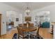 Dining room with a wood table, decorative rug and chandelier, with an open concept to the living room at 5372 Lenox Ct, Castle Rock, CO 80104
