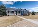 Charming two-story home with blue siding, a covered porch, and well-maintained landscaping at 5372 Lenox Ct, Castle Rock, CO 80104