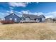 Backyard view of the home's exterior and deck, set on a large lot at 5372 Lenox Ct, Castle Rock, CO 80104