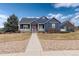 Inviting two-story home featuring a covered front porch, blue siding, and mature landscaping at 5372 Lenox Ct, Castle Rock, CO 80104