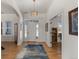 Bright foyer featuring hardwood floors, a decorative light fixture, and views to a living room at 5372 Lenox Ct, Castle Rock, CO 80104