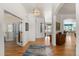 Elegant foyer with hardwood floors, a stylish light fixture, and open access to living areas at 5372 Lenox Ct, Castle Rock, CO 80104