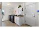 Laundry room featuring a side by side washer and dryer, storage cabinets, and a service door at 5372 Lenox Ct, Castle Rock, CO 80104