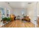 Bright living room offering hardwood floors, vintage desk, a comfortable reading area, and natural lighting at 5372 Lenox Ct, Castle Rock, CO 80104