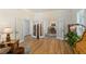 Open living room featuring hardwood floors and large glass doors leading to a dining area at 5372 Lenox Ct, Castle Rock, CO 80104