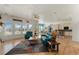 Open concept living room featuring hardwood floors, large windows, and seamless flow to dining and kitchen at 5372 Lenox Ct, Castle Rock, CO 80104