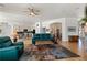 Open living space with hardwood floors seamlessly connecting the living area, dining area, and kitchen at 5372 Lenox Ct, Castle Rock, CO 80104