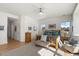 Main bedroom featuring a wooden bed frame, hardwood floors, ceiling fan, and a large window at 5372 Lenox Ct, Castle Rock, CO 80104