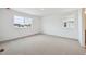 Comfortable bedroom with neutral carpet, ample natural light from large windows at 24717 E 40Th Ave, Aurora, CO 80019