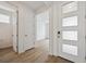 Bright entryway with modern white door with rectangular glass and light wood flooring at 24717 E 40Th Ave, Aurora, CO 80019