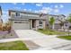 Charming two-story home with grey exterior, neat landscaping, and a concrete driveway at 24717 E 40Th Ave, Aurora, CO 80019