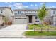 Charming two-story home with grey exterior, neat landscaping, and a concrete driveway at 24717 E 40Th Ave, Aurora, CO 80019