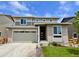 Charming two-story home featuring a two-car garage and manicured lawn at 24717 E 40Th Ave, Aurora, CO 80019