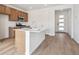 Modern kitchen featuring an island with a white countertop, stainless steel appliances and light wood flooring at 24717 E 40Th Ave, Aurora, CO 80019