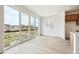 Open concept living room with light flooring, large sliding glass doors to backyard at 24717 E 40Th Ave, Aurora, CO 80019