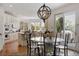 Bright eat-in kitchen with views to the backyard has modern appliances, an island, and a dining table at 9479 S Shadow Hill Cir, Lone Tree, CO 80124