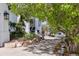 Well-maintained front yard with landscaping, walkway, mature tree and a charming white home at 9479 S Shadow Hill Cir, Lone Tree, CO 80124