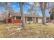Brick ranch home with attached garage and mature trees at 340 S Swadley St, Lakewood, CO 80228