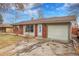 Brick ranch home with attached garage and landscaped yard at 340 S Swadley St, Lakewood, CO 80228