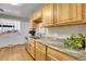 Kitchen with wood cabinets, granite countertops, and stainless steel appliances at 340 S Swadley St, Lakewood, CO 80228