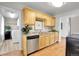 Bright kitchen, wood cabinets, granite countertops, and access to laundry at 340 S Swadley St, Lakewood, CO 80228