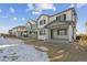 Exterior view of two story home with backyard and snow at 17811 E 93Rd Ave, Commerce City, CO 80022