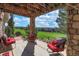 Inviting back porch with stone columns and views of the green golf course at 6638 S Tibet Ct, Aurora, CO 80016