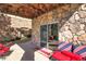 Covered patio featuring stone accents and comfortable seating with patriotic pillows at 6638 S Tibet Ct, Aurora, CO 80016