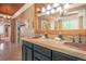 Luxurious bathroom features a double sink vanity, elegant mirrors, and warm lighting for a relaxing ambiance at 6638 S Tibet Ct, Aurora, CO 80016